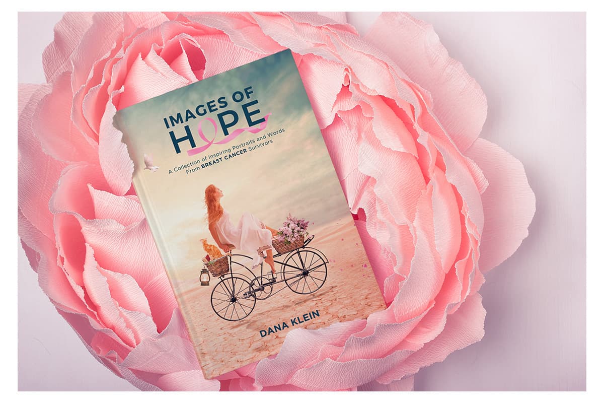 Images of Hope — fine art portrait book by composite artist Dana Klein, resting on pink roses